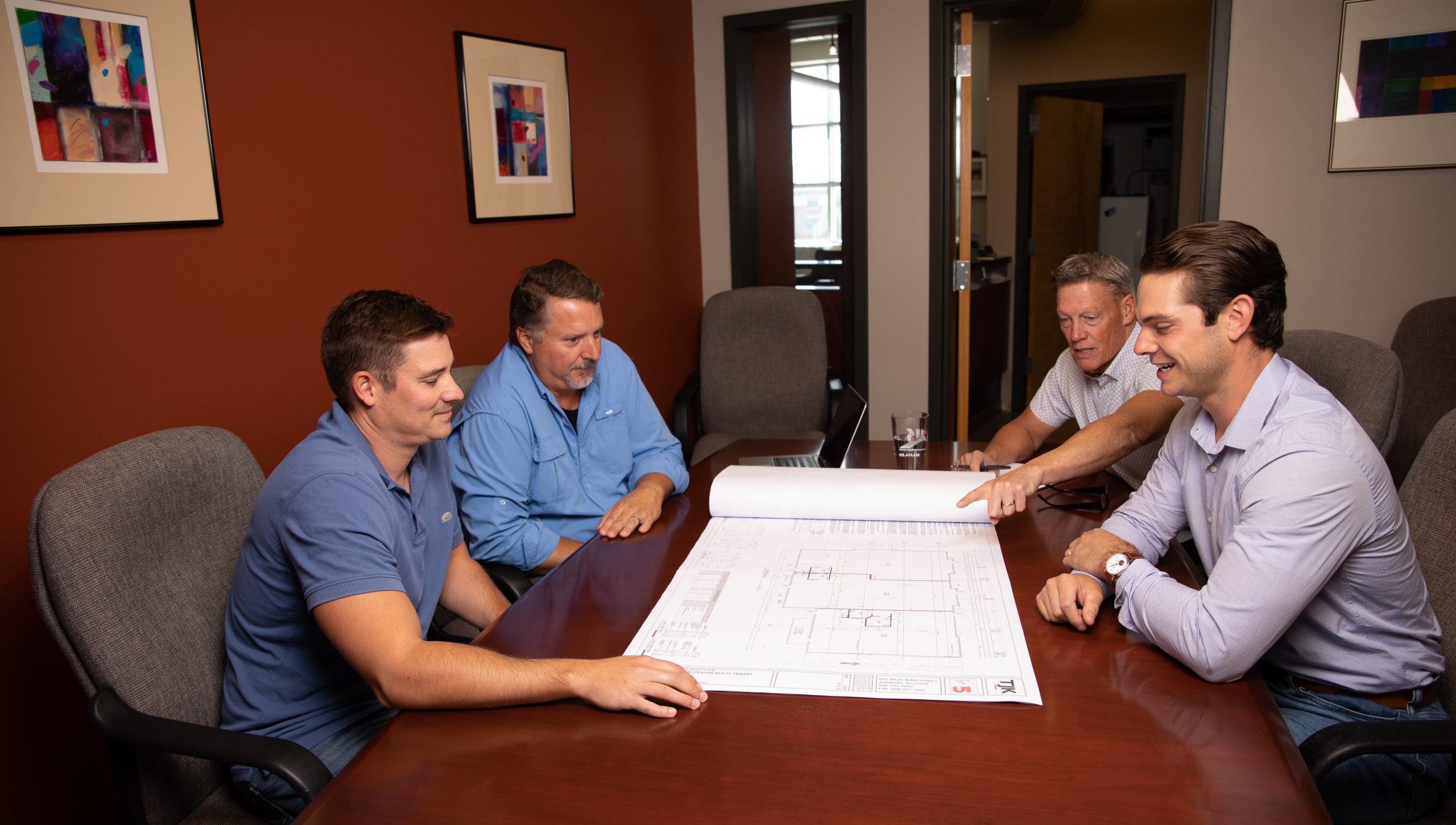 Team reviewing design drawing